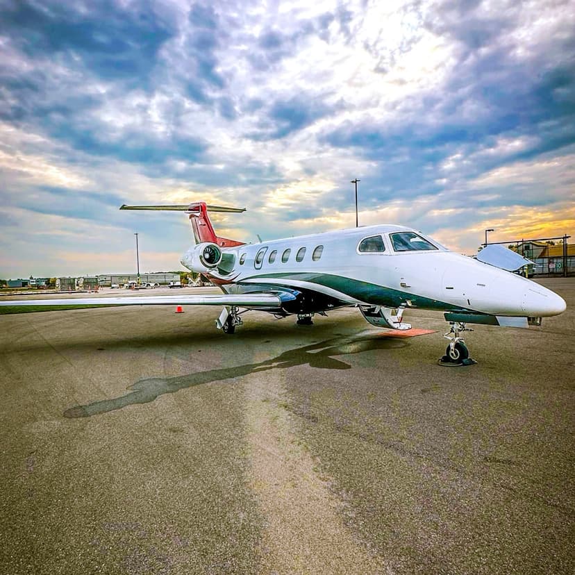 Embraer Phenom 300 on the ramp under dramatic sky
